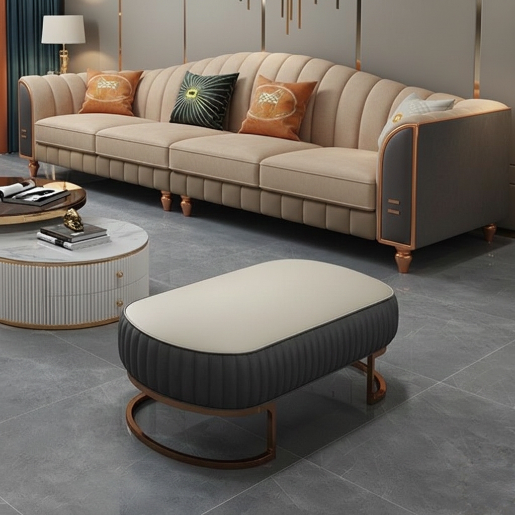 Luxury beige and grey modern sofa with curved backrest, gold accents, and decorative pillows in a premium living room.