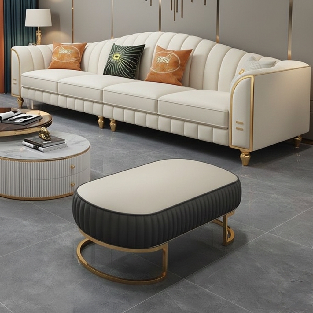 Ivory white luxury sofa with gold detailing and decorative throw pillows in an upscale living room.