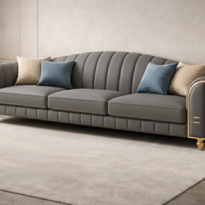 Charcoal grey luxury sofa with gold accents in a modern grey-toned living room.