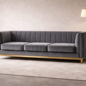 Charcoal grey vertical-tufted 3-seater sofa with gold base detailing in a modern living room.