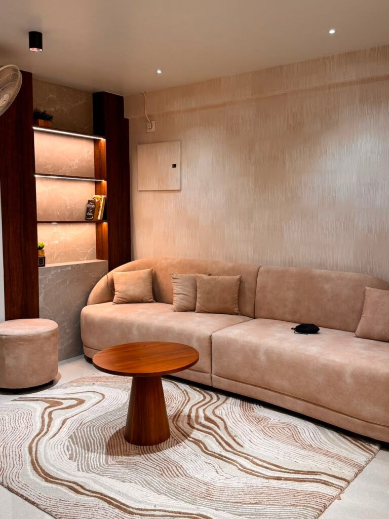 Warm neutral living room in a Trivandrum home, an example of interior design for humid climate conditions in Kerala
